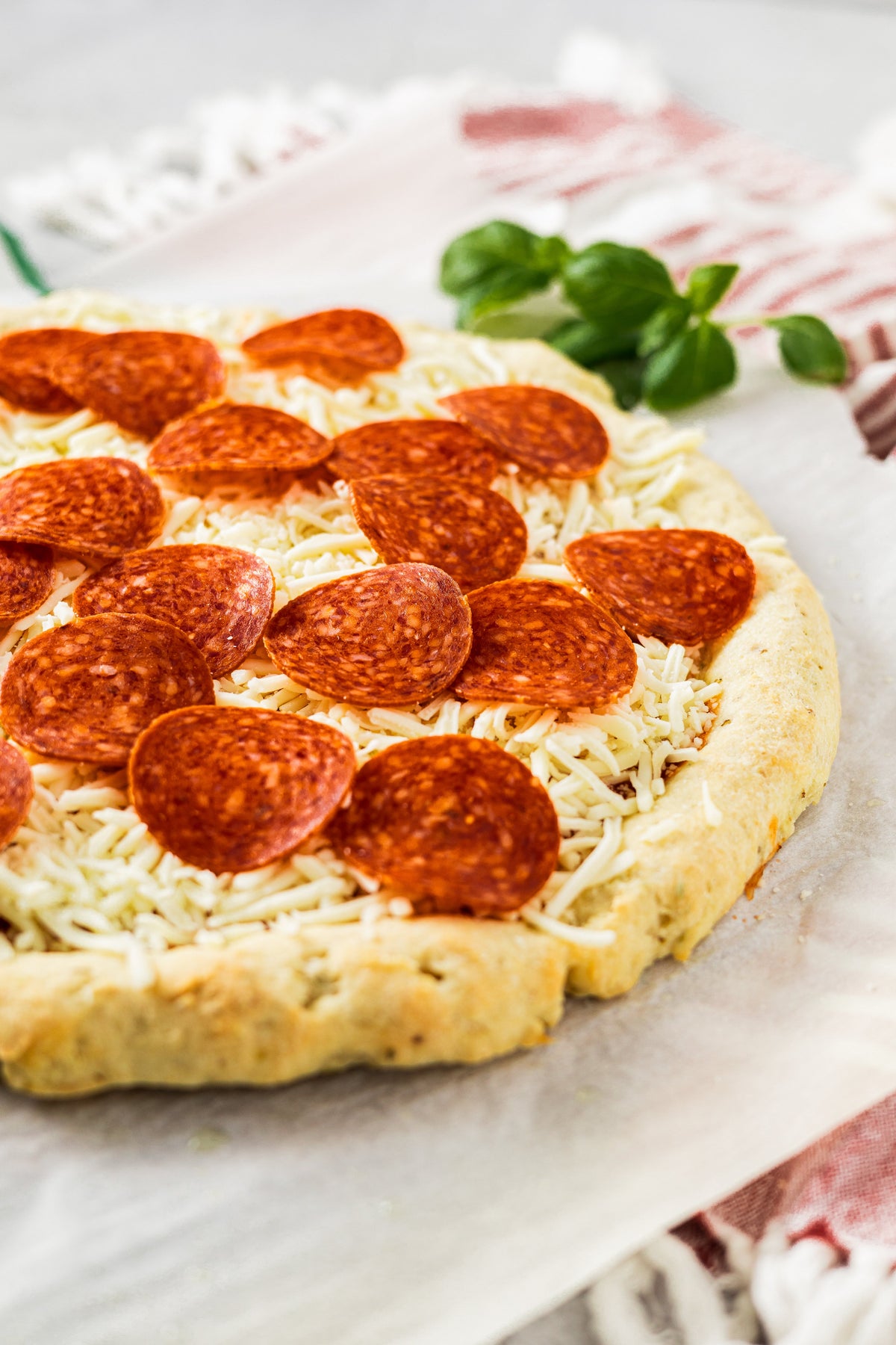 Gluten-free pizza topped with pepperoni slices and shredded cheese