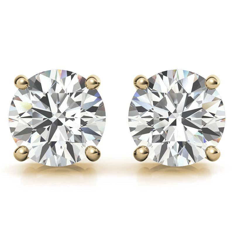Pair of round diamond stud earrings with four-prong settings in gold