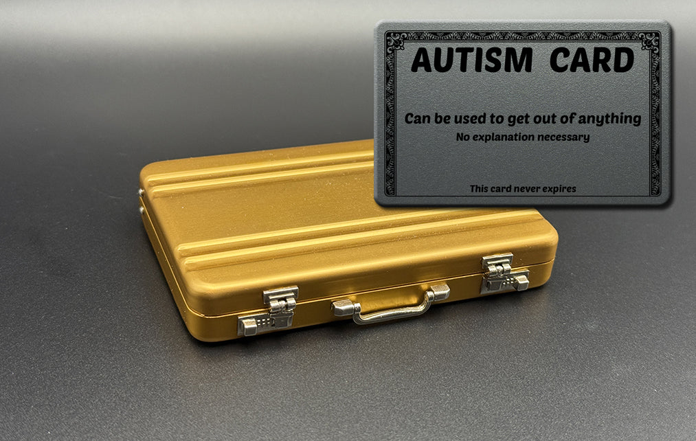 Mini briefcase, gold metal case with Autism card overlay