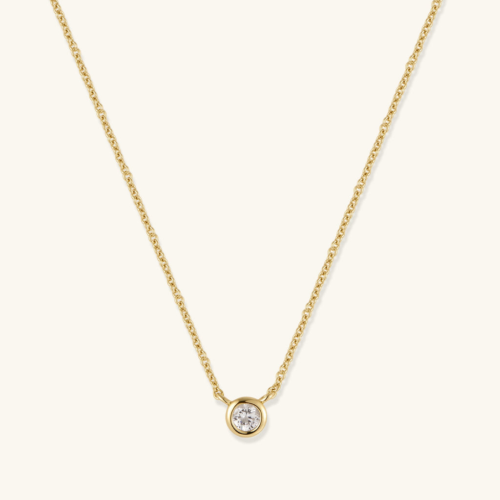 Gold chain necklace with round bezel-set diamond pendant