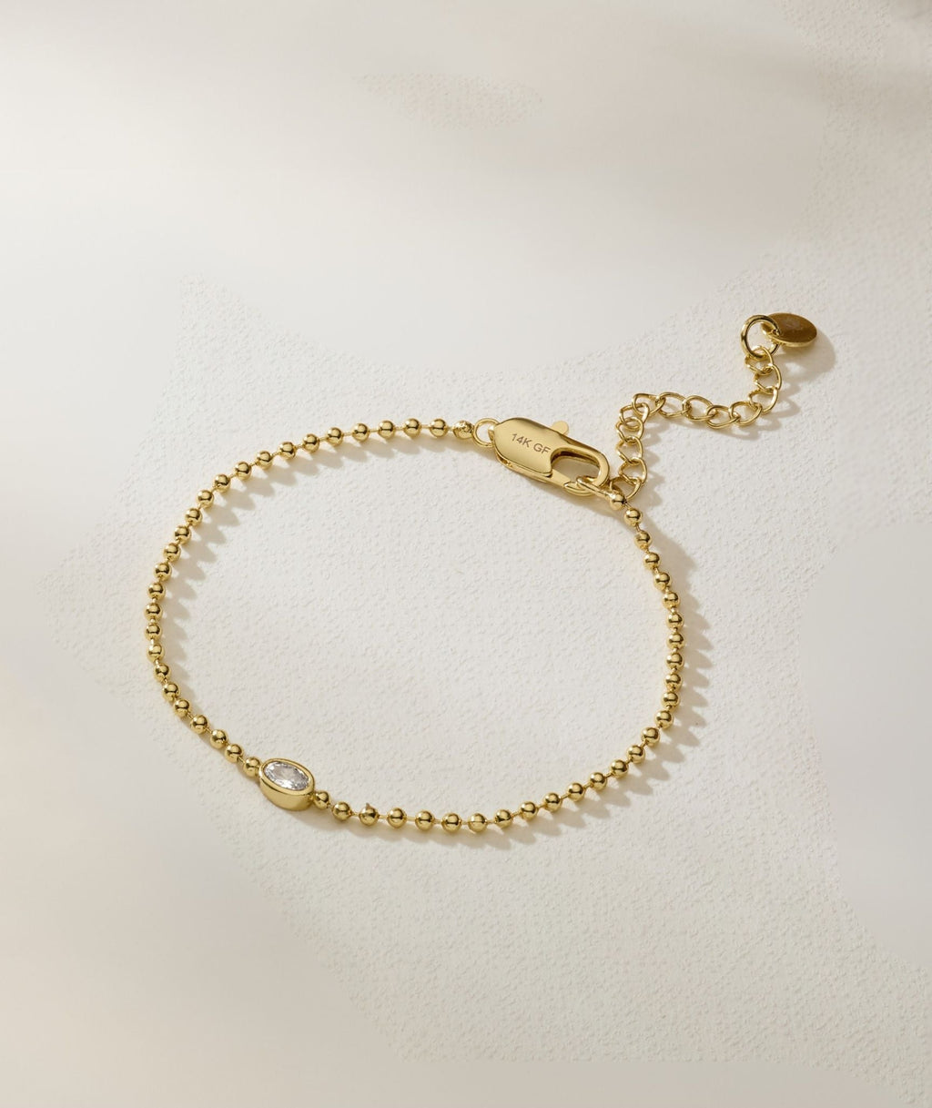 Gold oval bracelet with toggle clasp and oval diamond detail at center