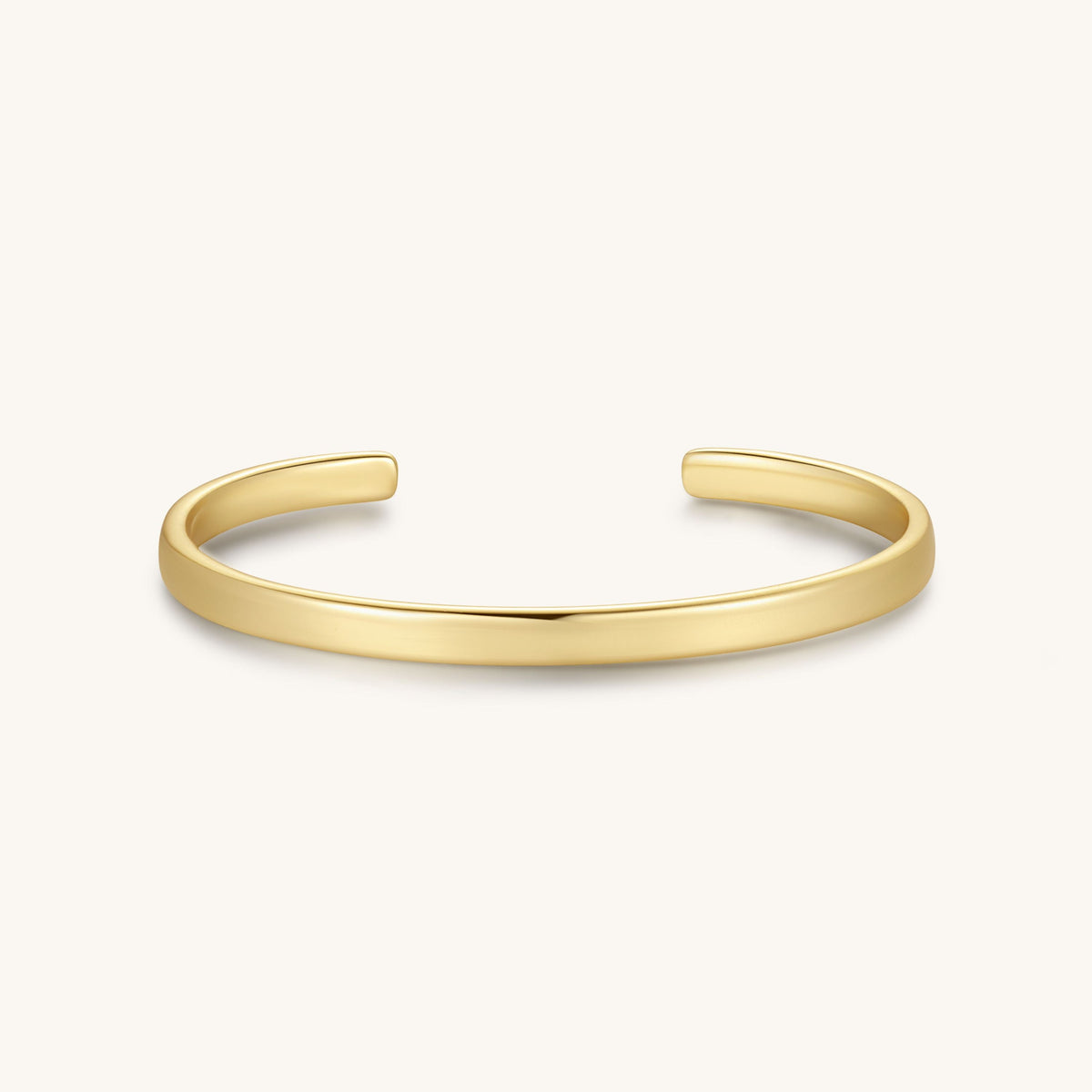 Gold-tone cuff bracelet with a smooth, flat band and open sides.