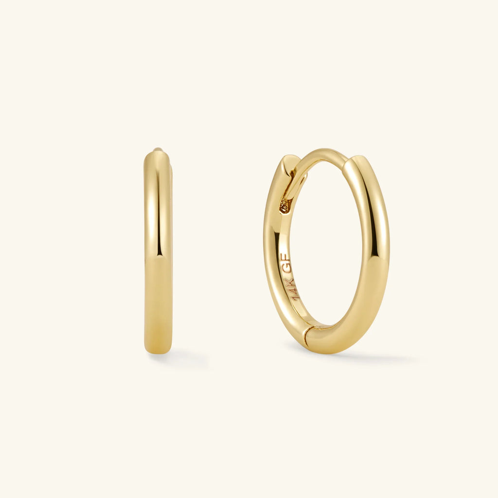 Gold hoop earrings pair: smooth hoop and circular hoop with bezel-set stones