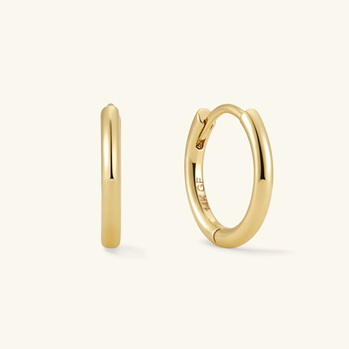 Gold hoop earrings pair: smooth hoop and circular hoop with bezel-set stones