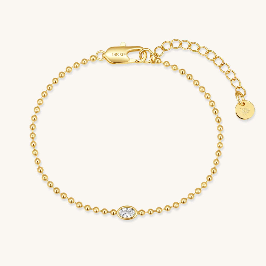 Gold beaded bracelet with oval crystal diamond charm and 14K GF tag