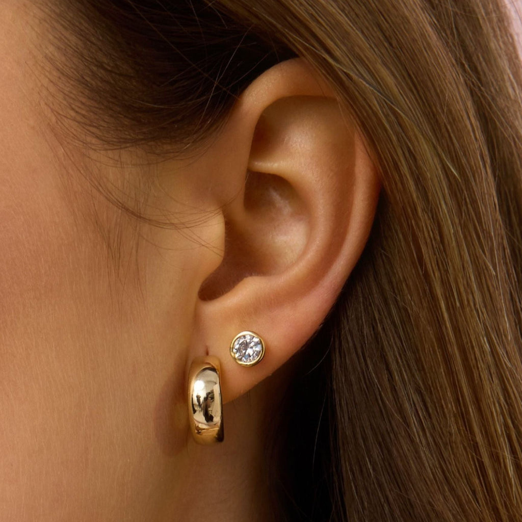 Gold round diamond bezel stud earrings with small back post visible