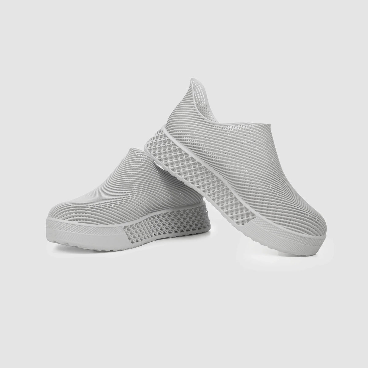 Light gray 3D printed slip-on sneakers with ribbed knit upper and textured sole