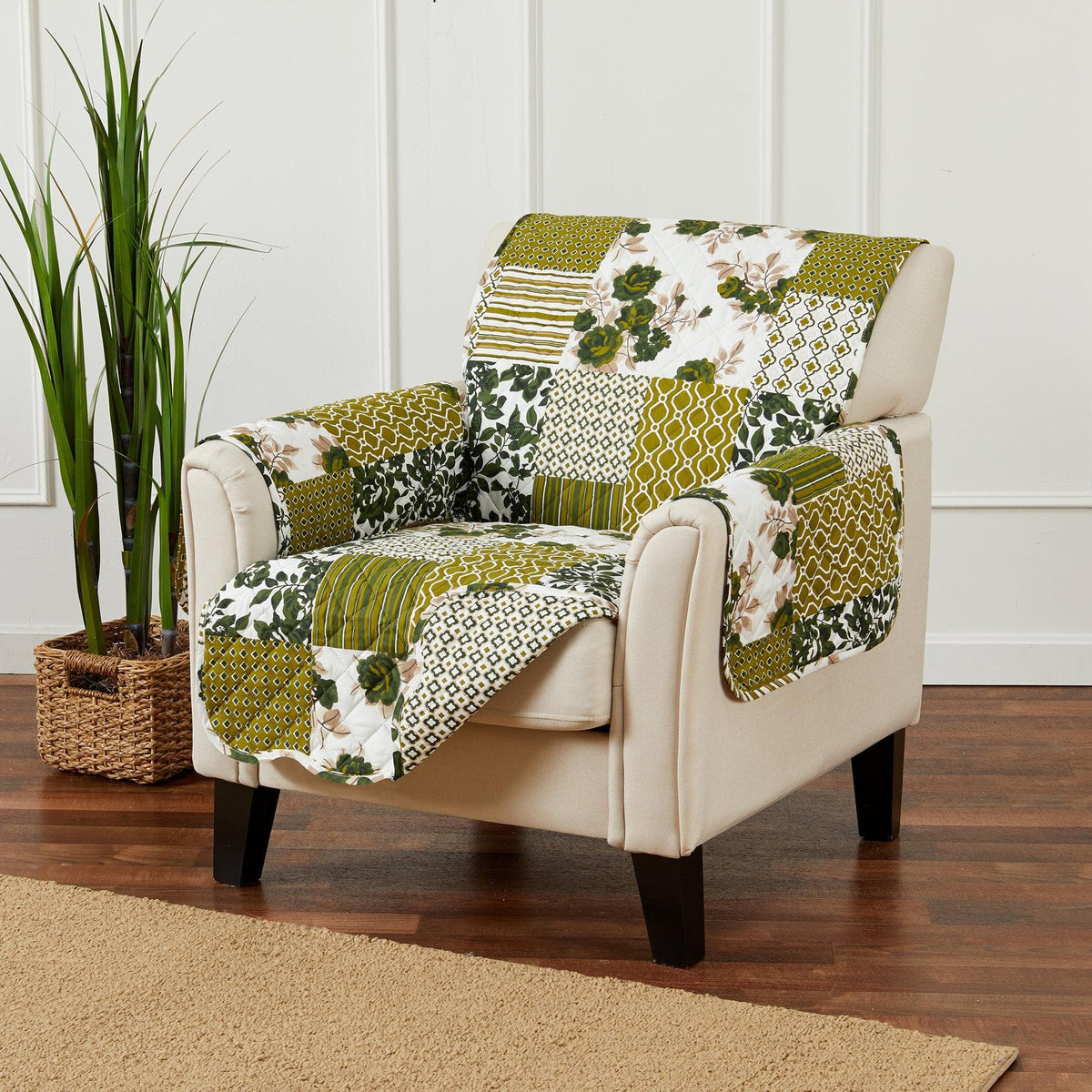Reversible sofa protector with green, yellow, and white floral and geometric patchwork