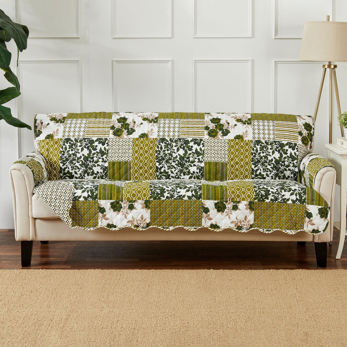 Reversible furniture protector in green and white patchwork, fitted to sofa with arm cover