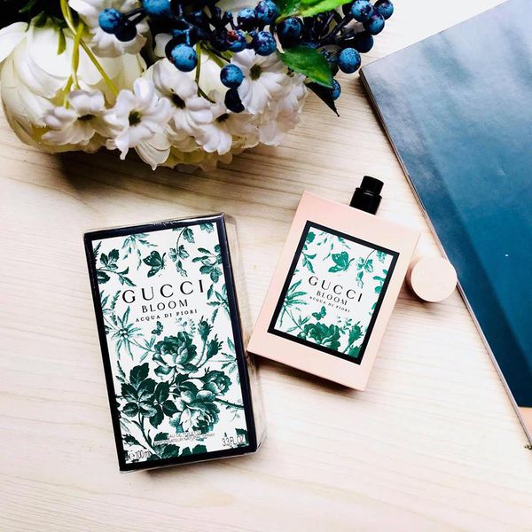 Pink perfume bottle with matching box and Gucci Bloom green floral label