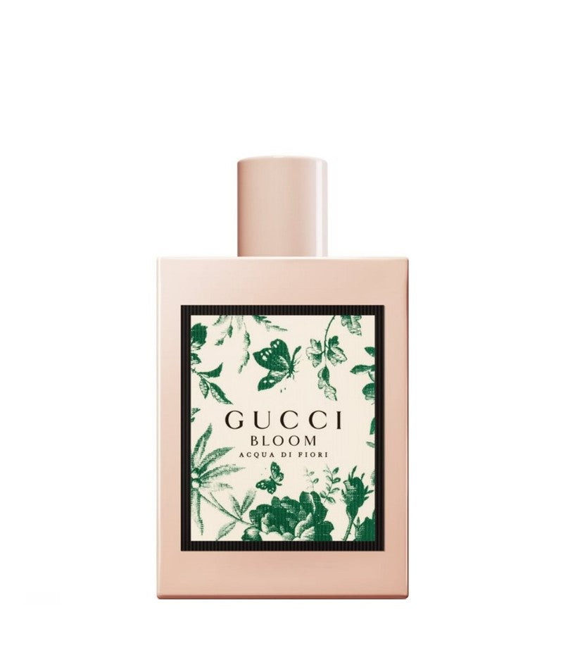 Pink perfume bottle with Gucci Bloom label and green floral botanical print