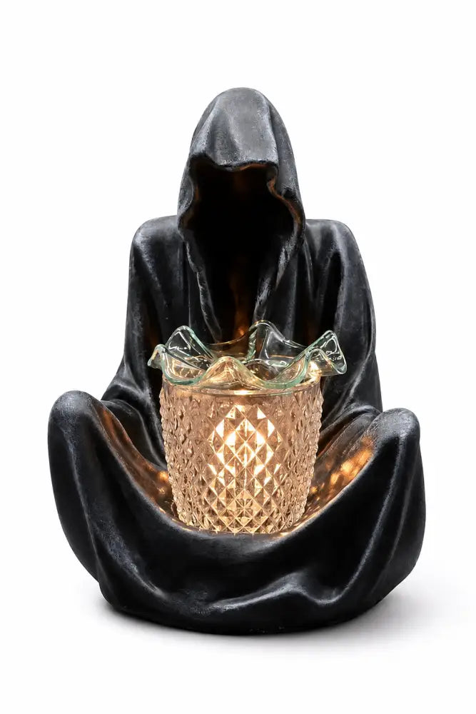 Grim reaper wax and oil warmer, dark hooded figure holding a glowing amber cup