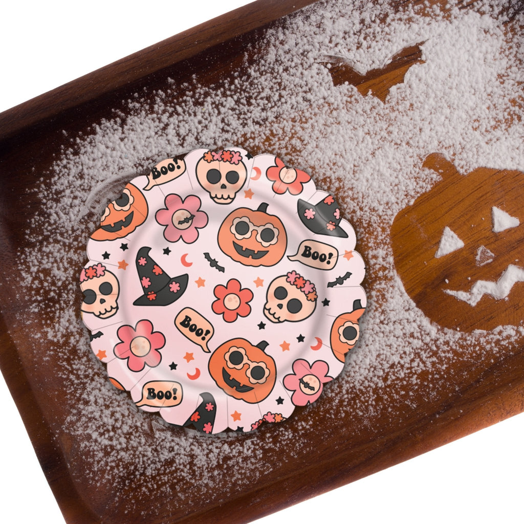 Groovy Halloween icon plates on a wooden surface, round plates with Halloween character prints