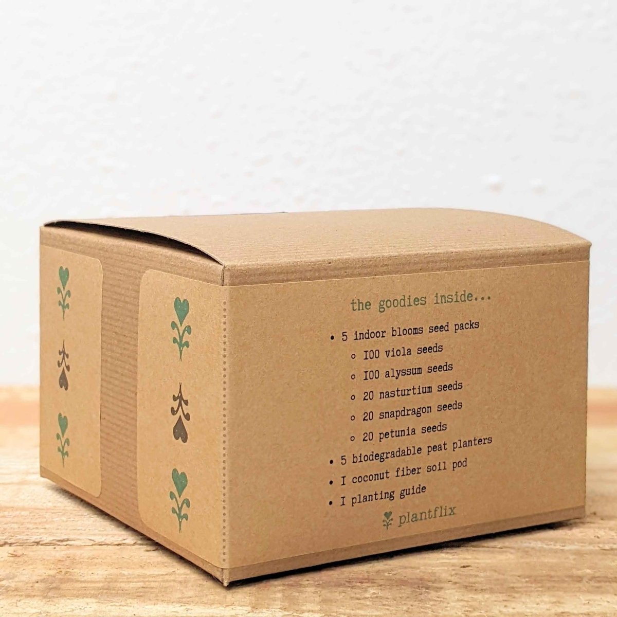 Kraft seed kit box side with green leaf icons and contents text