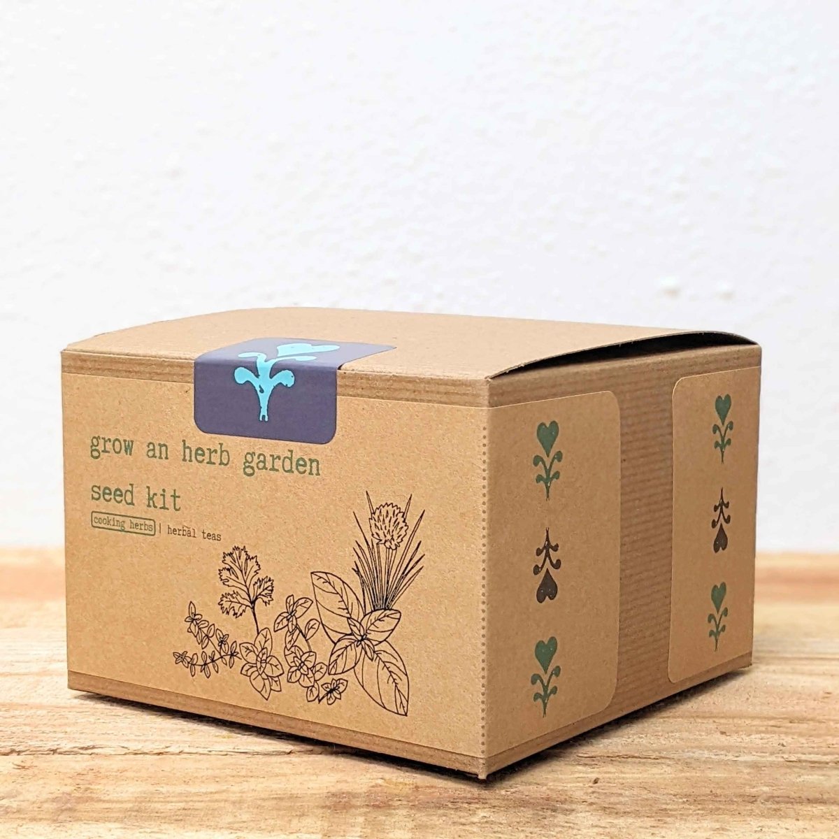Herb seed kit box with blue top label and side leaf icon panels