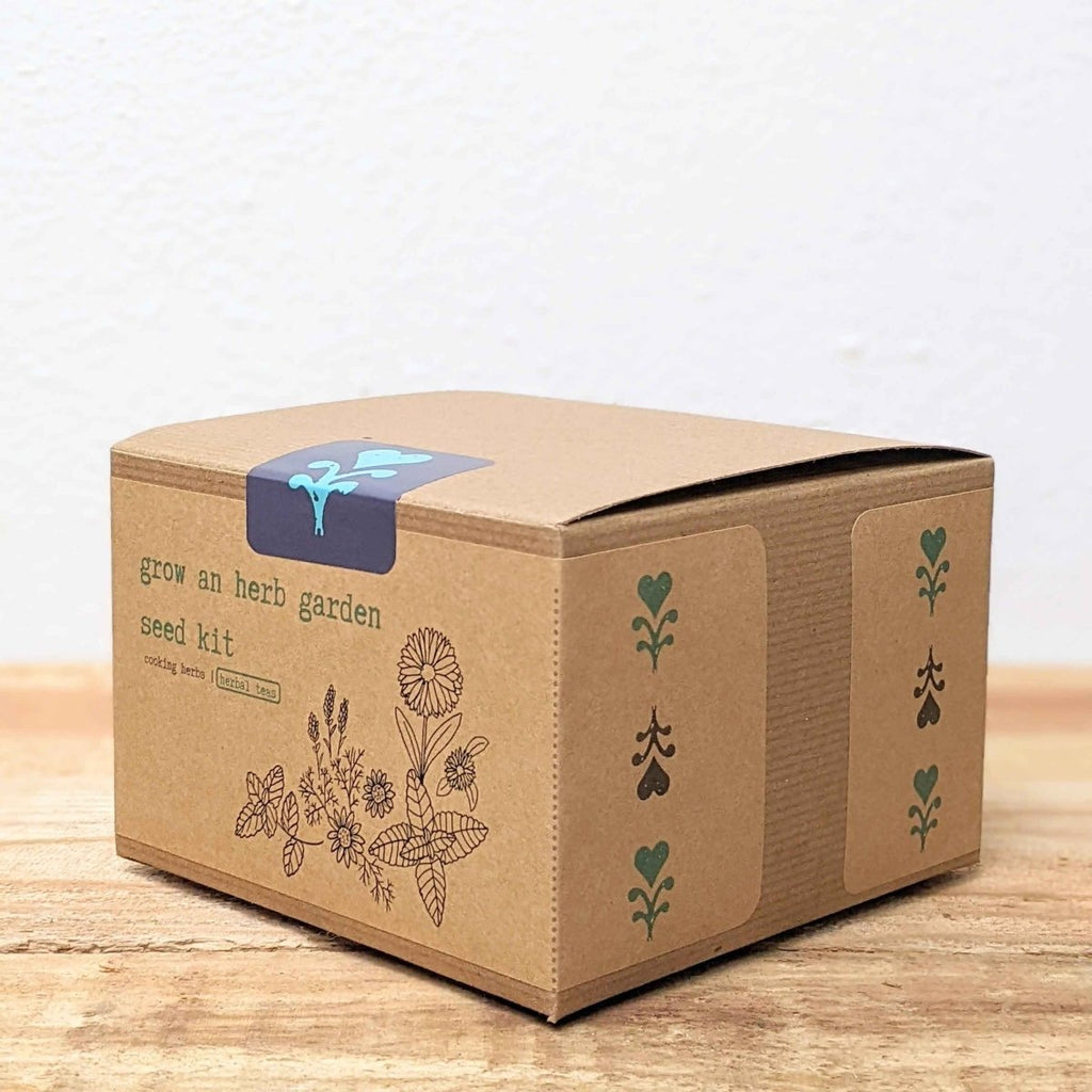 Herb garden seed kit box, brown kraft paper with blue emblem on top