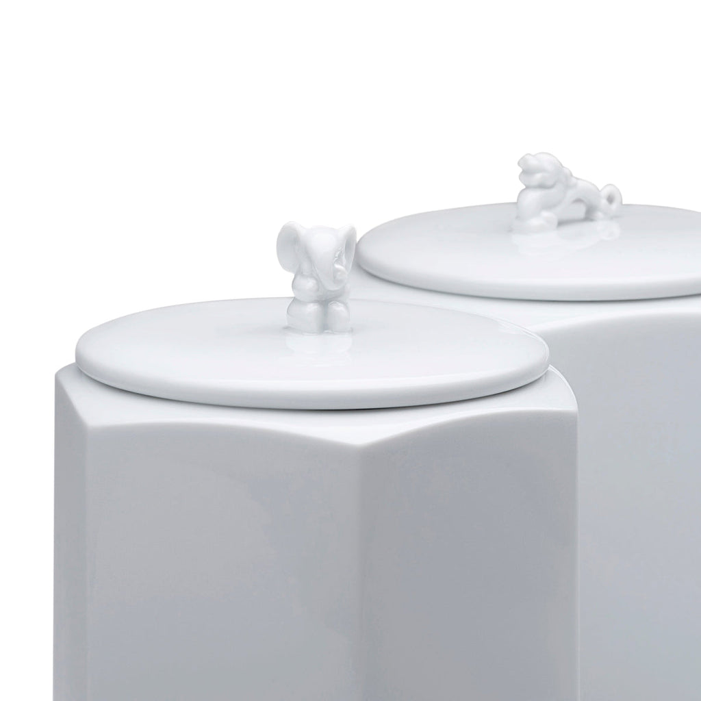 Close-up of white hexagonal porcelain jar lid with dragon figurine knob