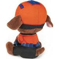 Stuffed Marshall plush toy in orange, blue and red firefighter outfit, soft brown ears.