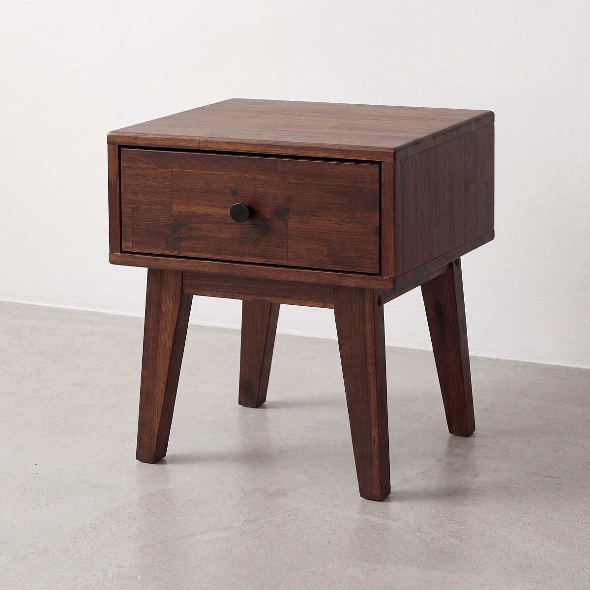 Solid wood nightstand with one drawer, centered round knob, four short legs
