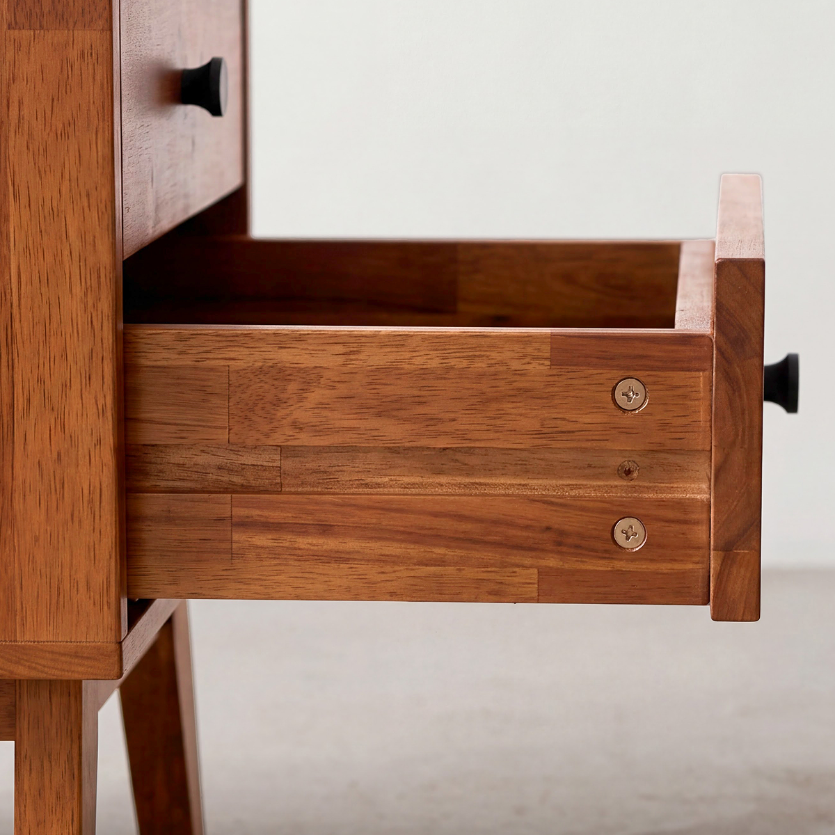 Silvia solid wood nightstand side view with open drawer and metal knob pulls