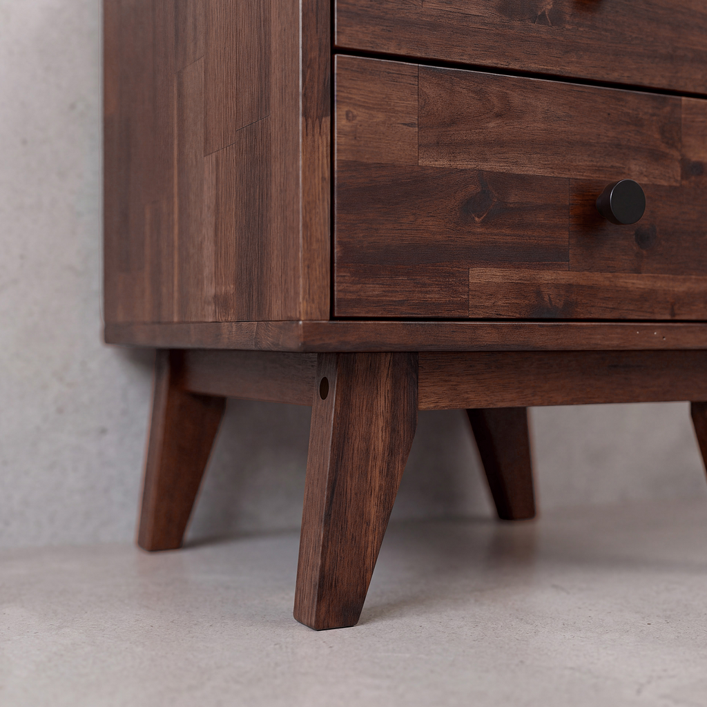 Close-up of solid wood nightstand drawer fronts and tapered wooden legs