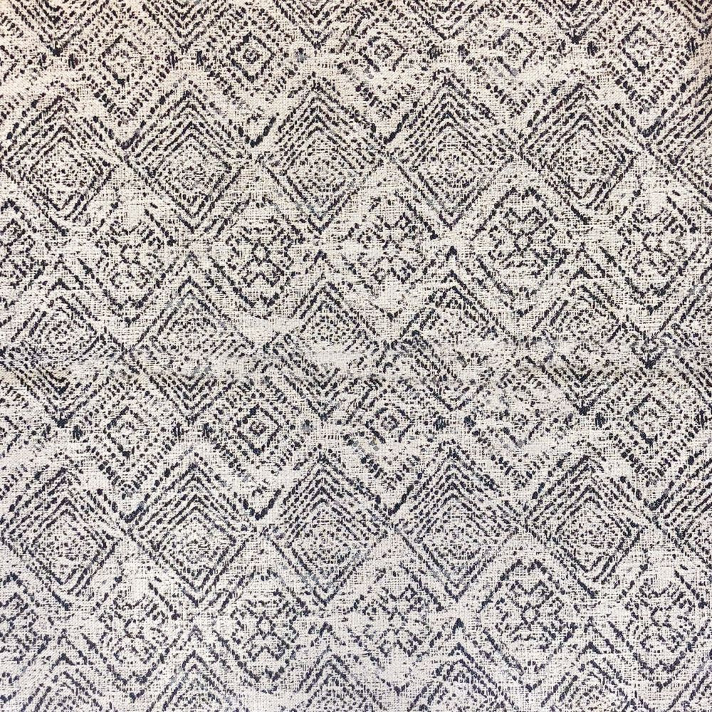 Close-up of gray zigzag patterned fabric cover with dark and light thread