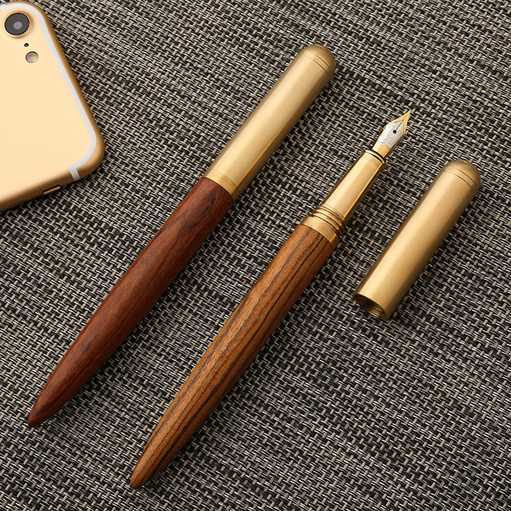Handmade fountain pen with dark wood barrel and brass trim, gold nib