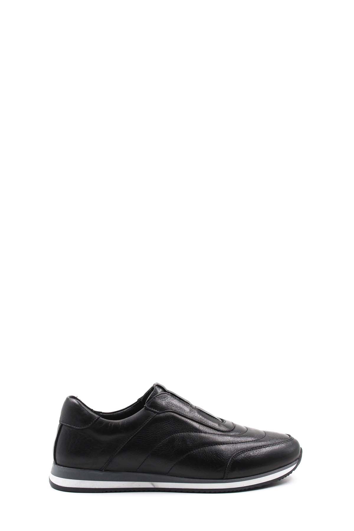 Black leather low-top sneakers with contrast white sole, side profile.