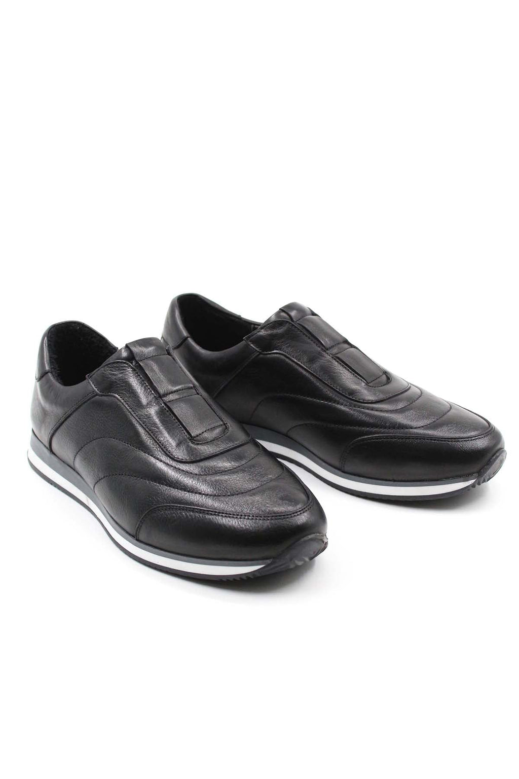 Pair of black leather low-top sneakers with contrast white soles, angled view.