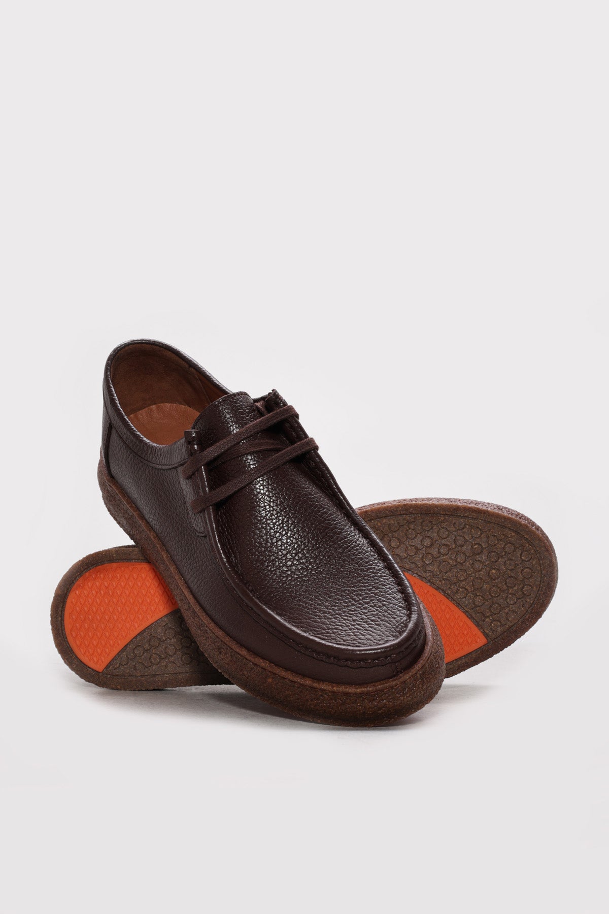 Men's dark brown leather lace-up casual shoe showing orange inner lining and outsole