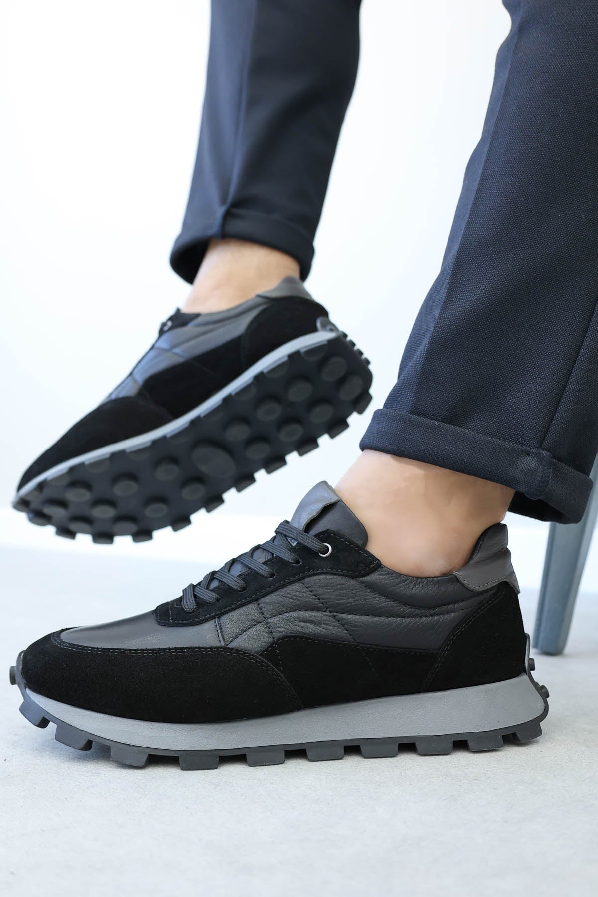 Men's black leather lug-sole sneakers by Wessi, lace-up with textured rubber outsole