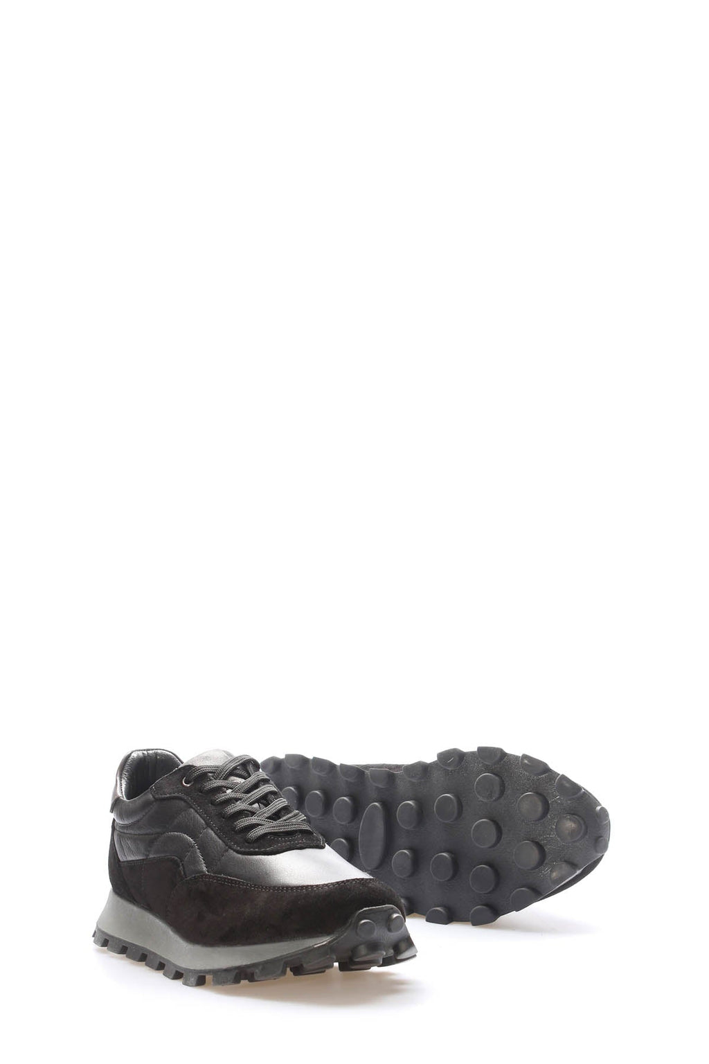 Pair of black leather lug-sole sneakers, heel and outsole detail, Wessi