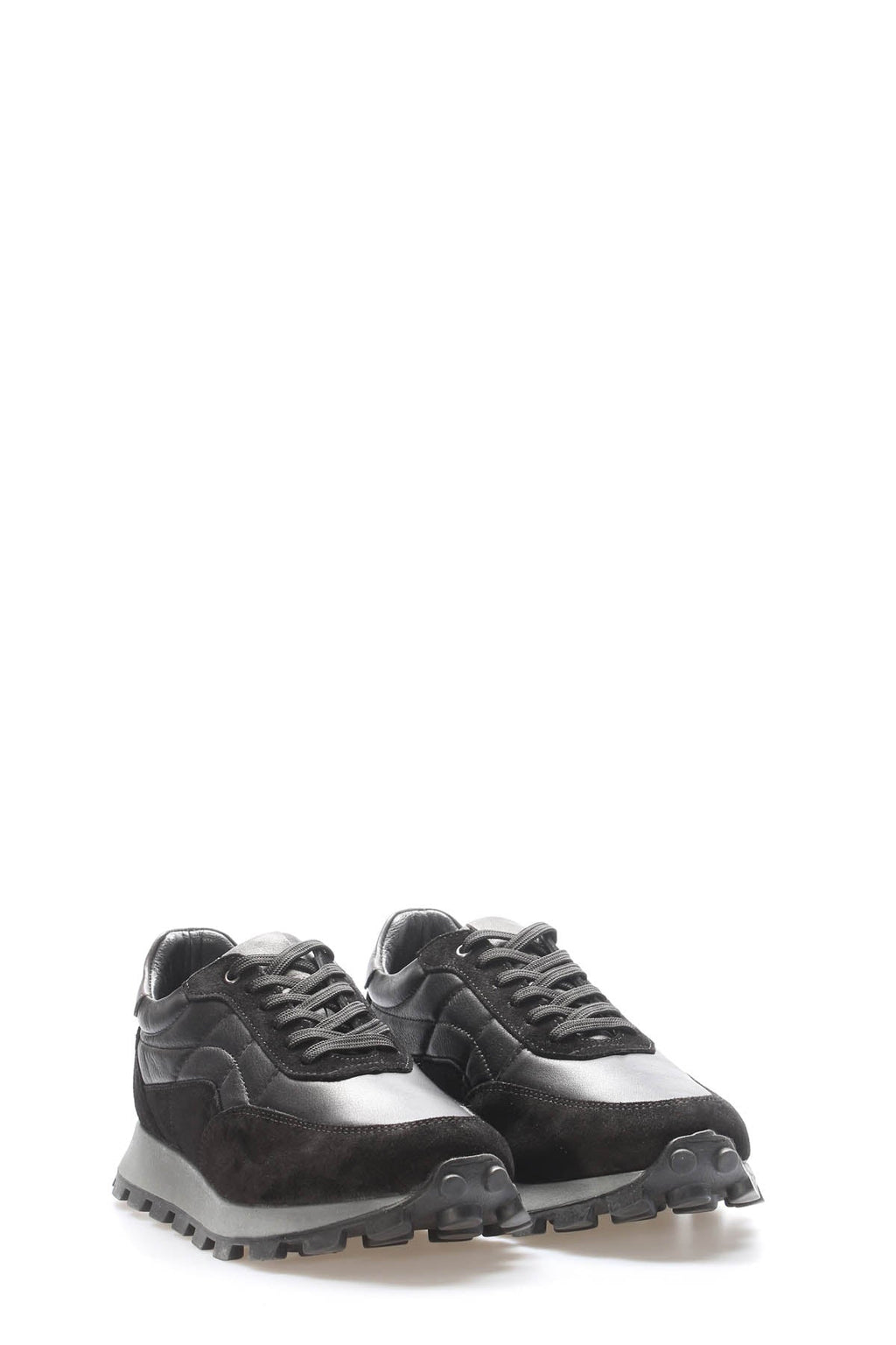 Black leather lace-up sneakers, close side-by-side view, chunky tread lug sole