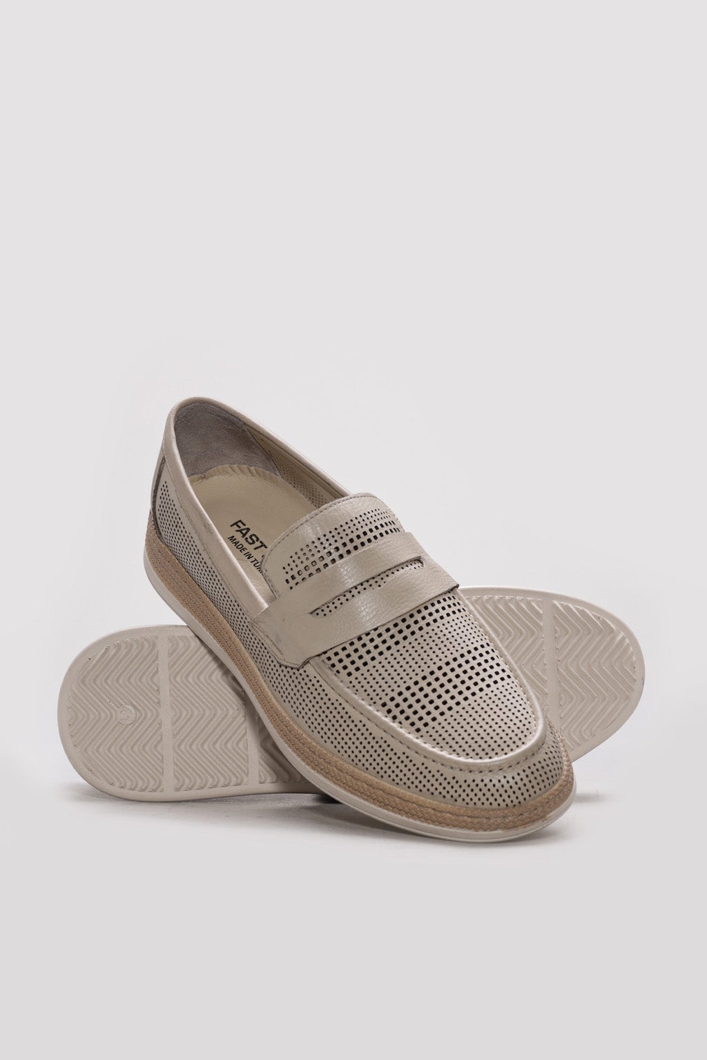 Beige perforated leather men’s loafer with cushioned insole and textured outsole