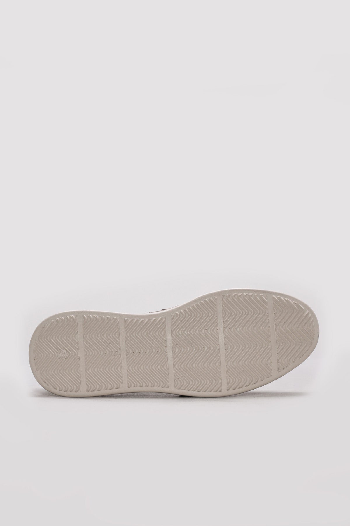 Beige perforated loafer outsole with textured tread