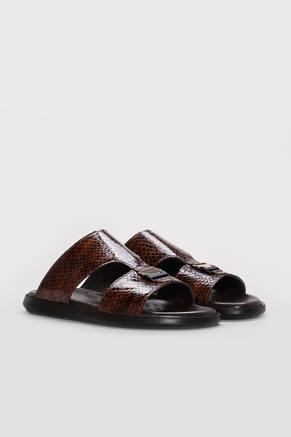 Brown reptile-textured leather double-band slides with black outsole and open toe