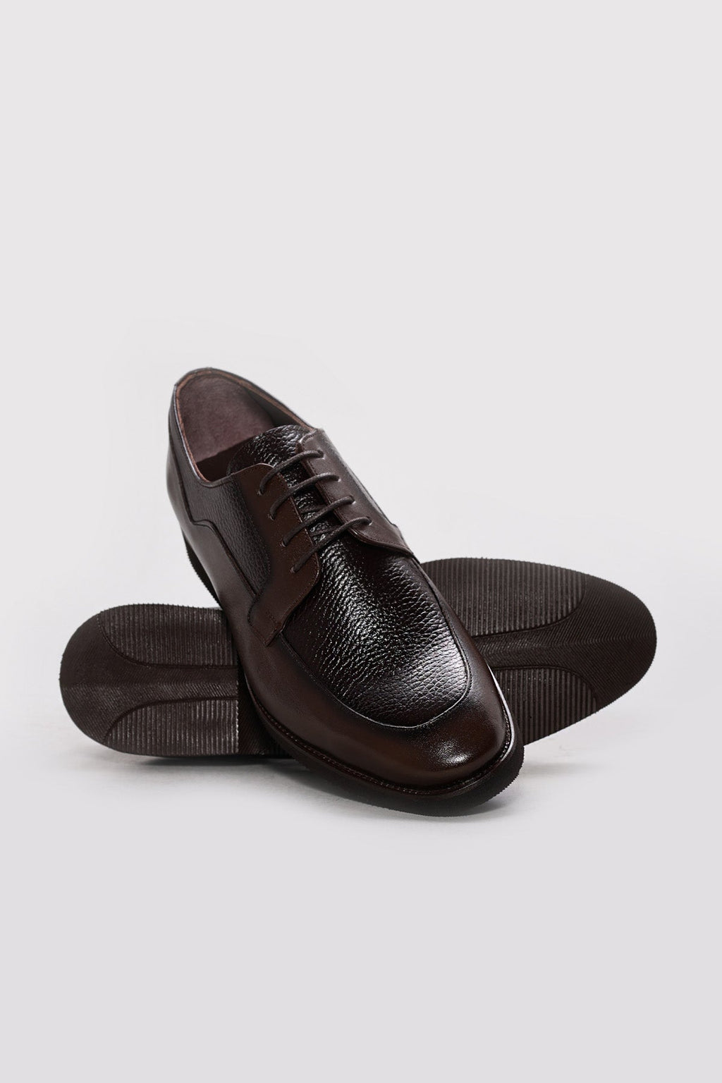 Men's dark brown leather derby shoes shown with sole and heel