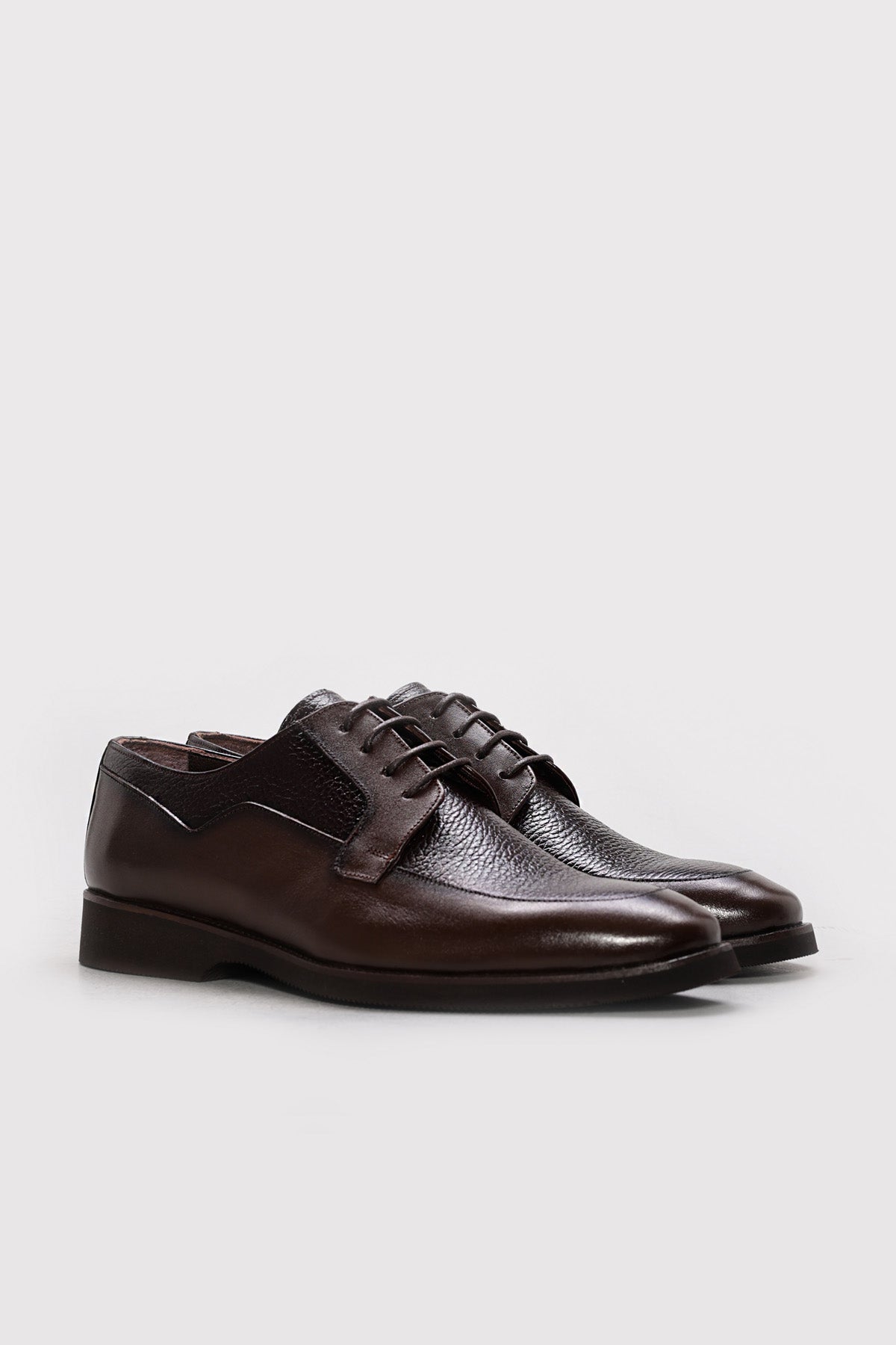 Men's dark brown leather derby shoes, lace-up front three-quarter view