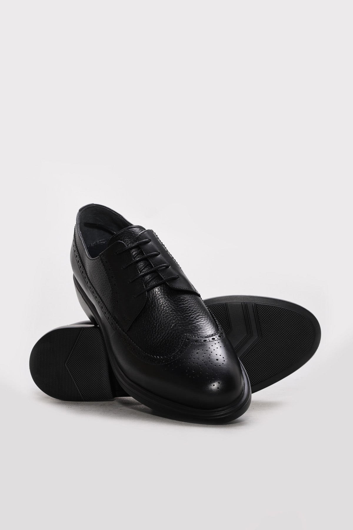 Men's black leather lace-up dress shoe with perforated toe detail and padded sole