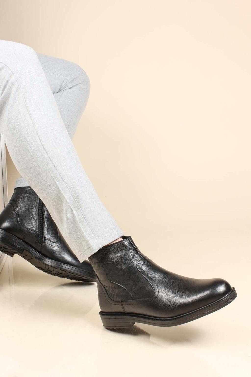 Men's black leather ankle boots with side zipper, angled side view