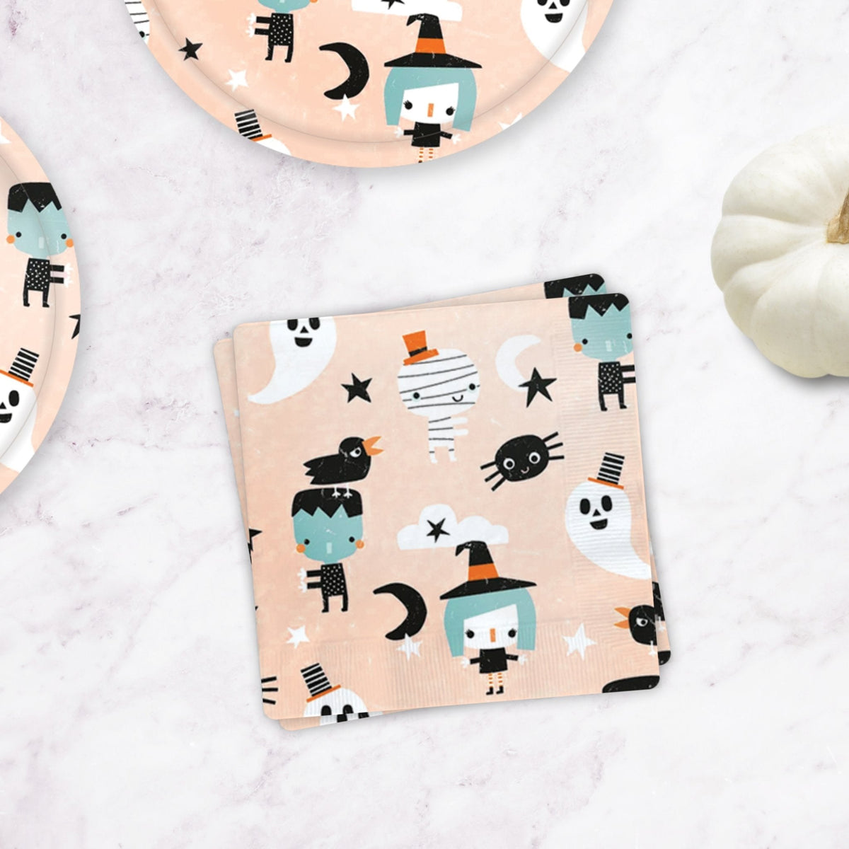 Halloween character paper napkin, peach with cartoon ghosts, bats, and cats