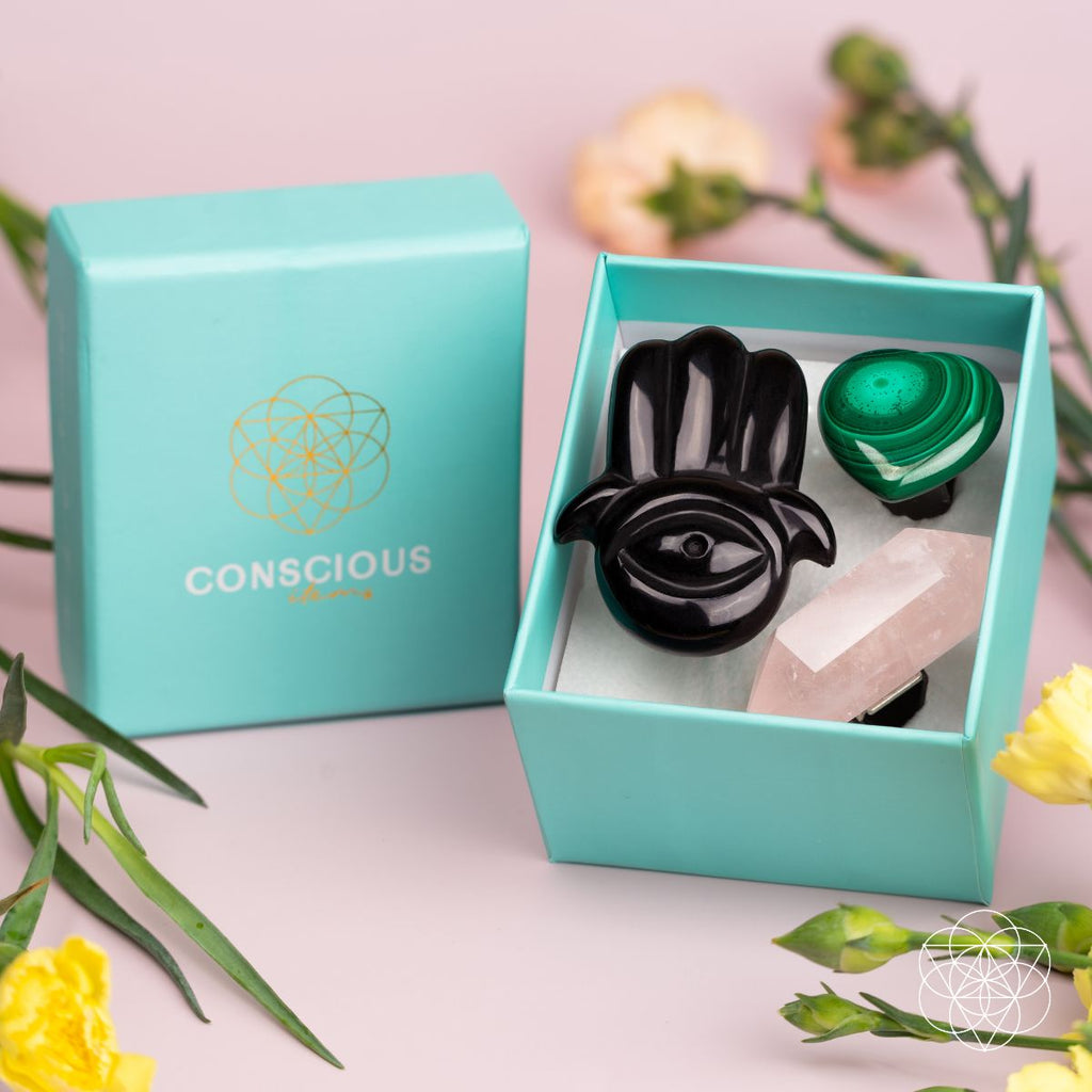 Gift box set with black hamsa diffuser, pink wand, and green heart crystal