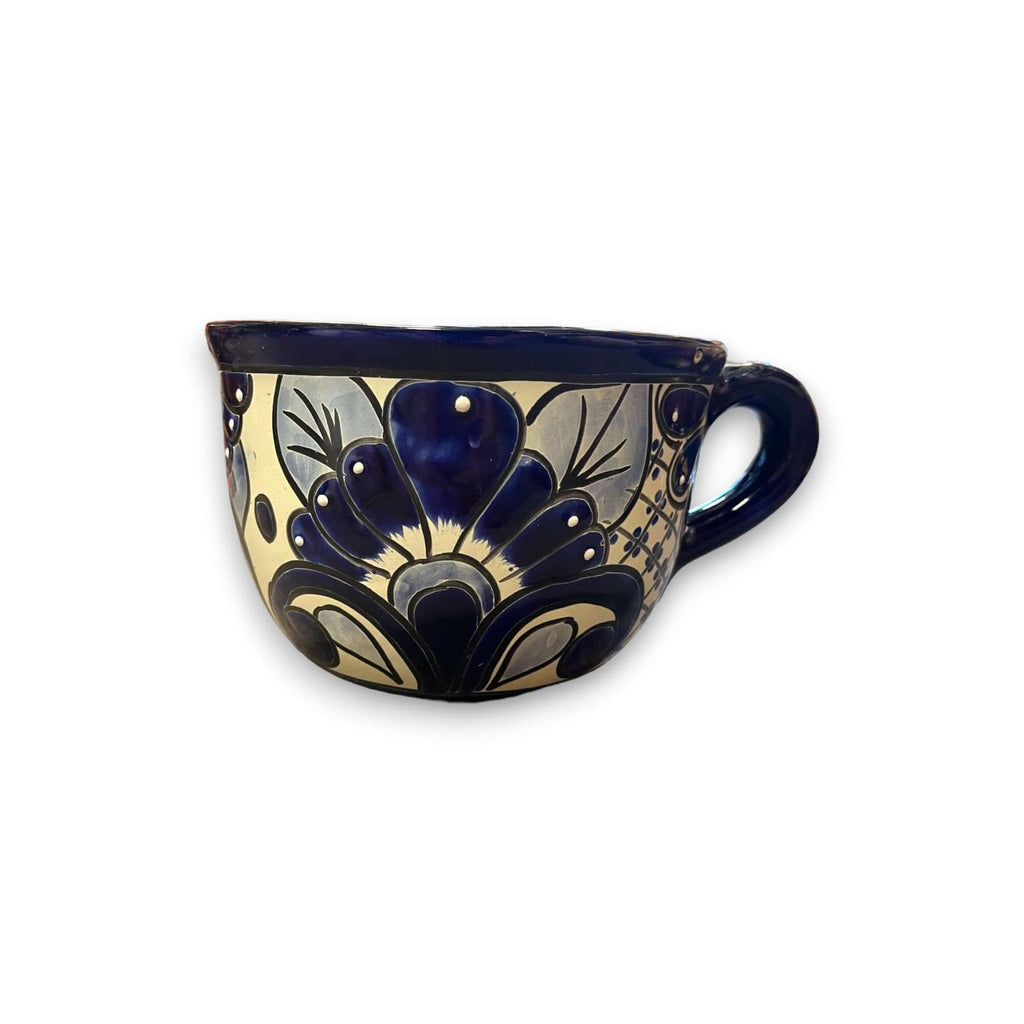 Hand-painted ceramic tea cup planter with dark blue handle and cream-and-blue floral pattern