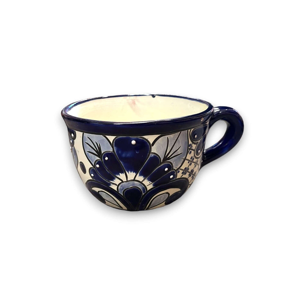 Hand-painted ceramic tea cup planter with dark blue handle and blue floral crest design