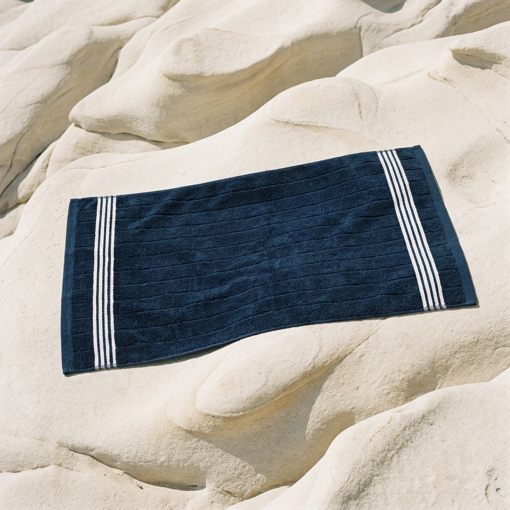Cotton towel, navy with white striped border