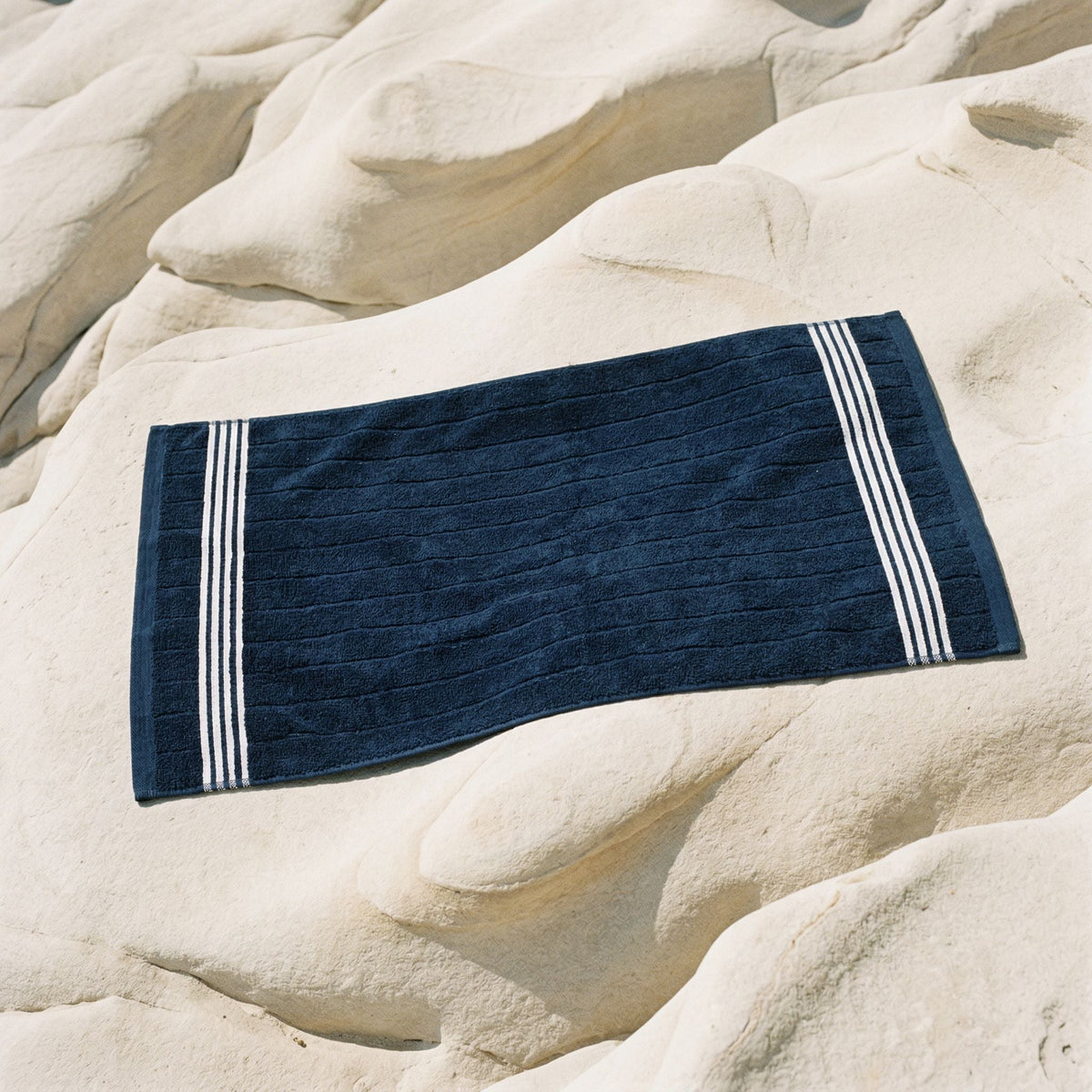Cotton towel, navy with white striped border