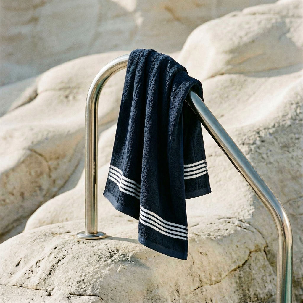 Cotton towel draped on rack, navy with white striped bands