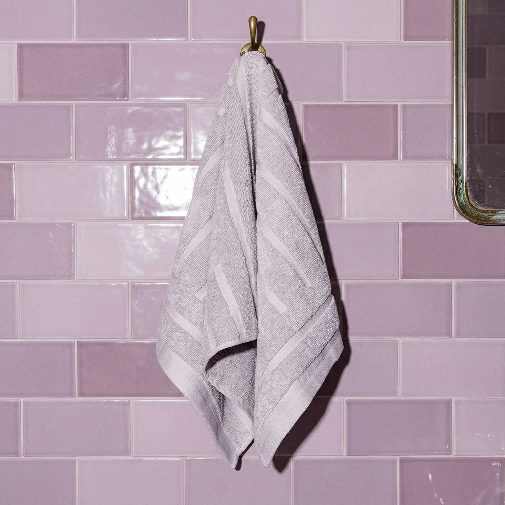 Lilac cotton towel, hanging by its corner loop