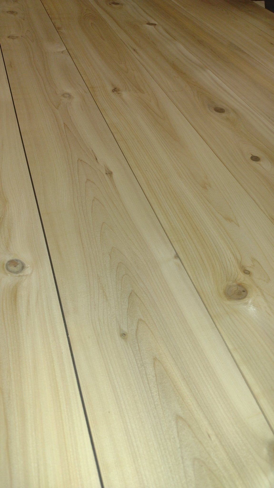 Light wood tabletop planks with visible grain and seams for outdoor picnic table