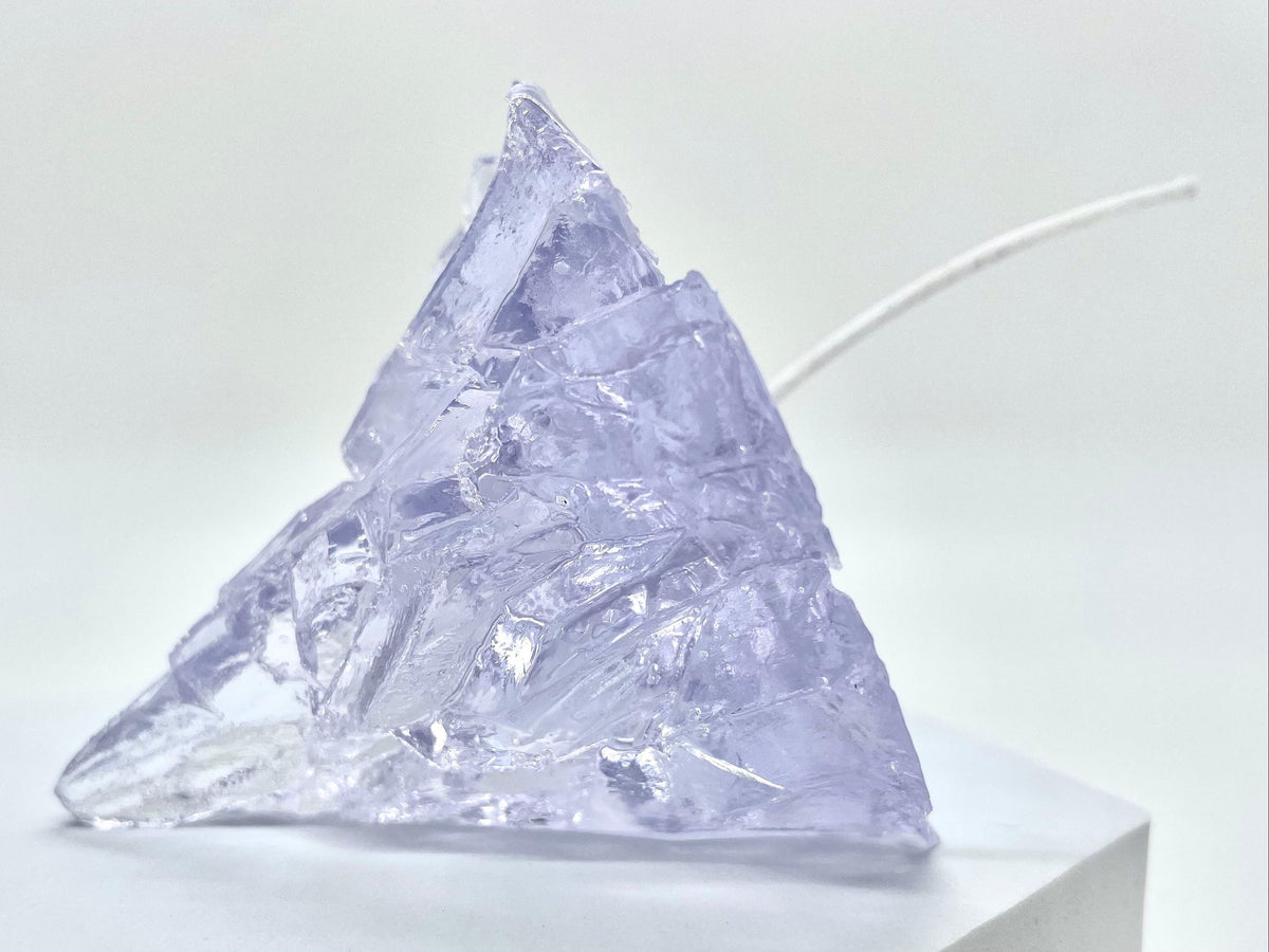 Light blue iceberg-shaped jelly wax candle with unlit wick, faceted translucent wax